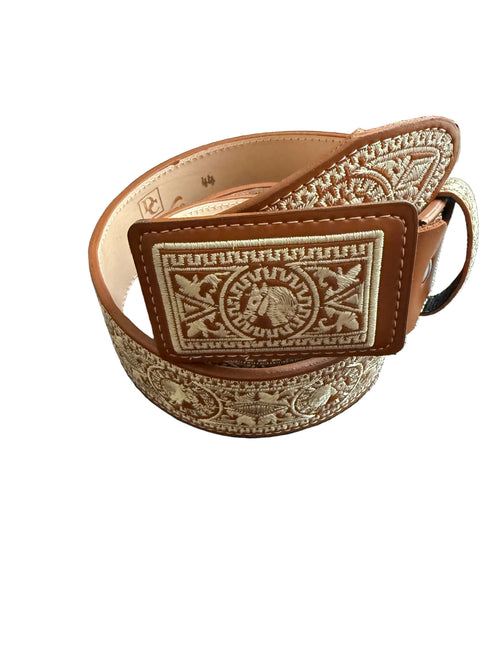 Decorative leather belt with intricate patterns on a wooden surface